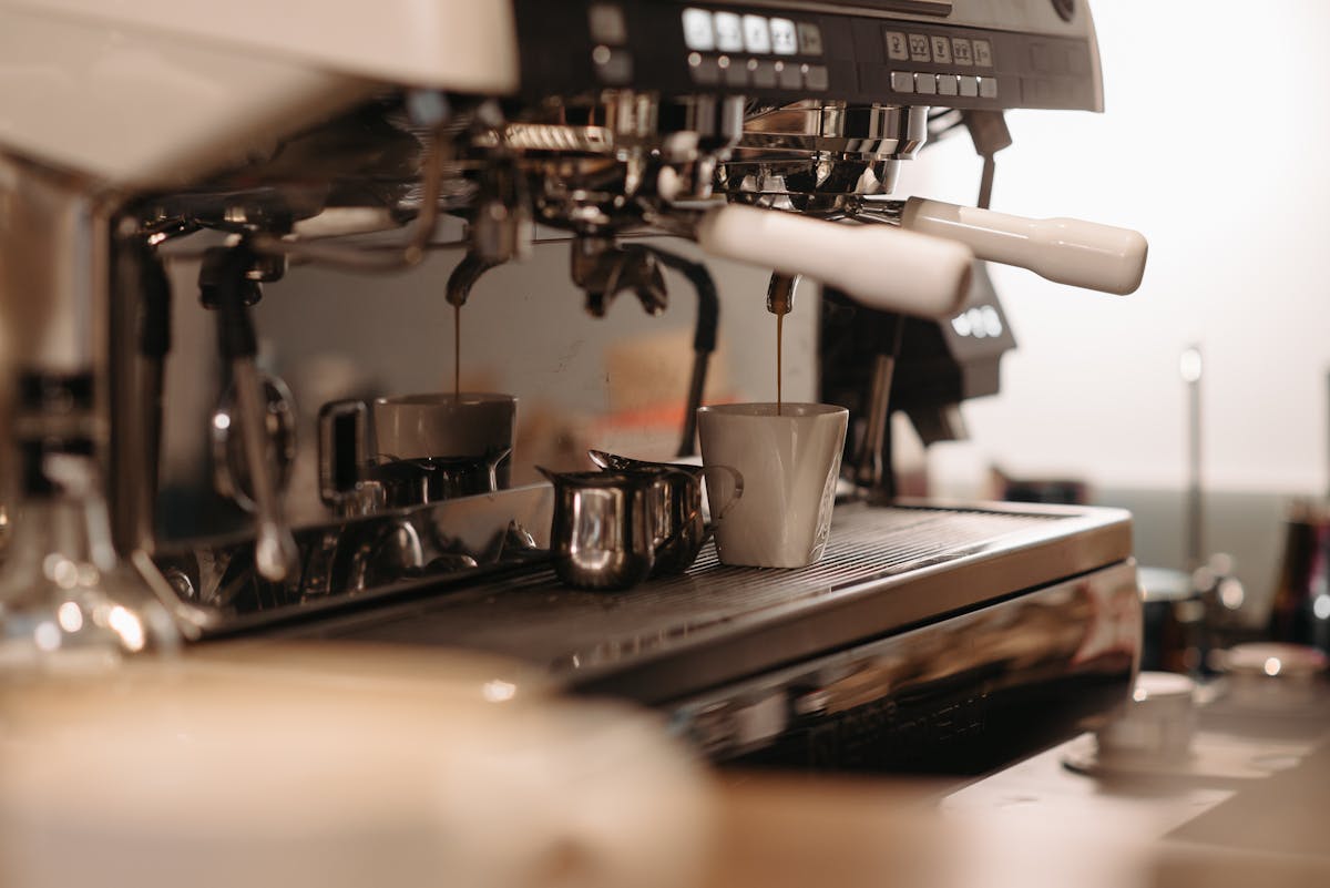 Extraction d'un espresso, le café coule en filet ambré dans la tasse